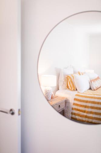 a mirror reflection of a bed in a bedroom at Under the Oak in Greytown