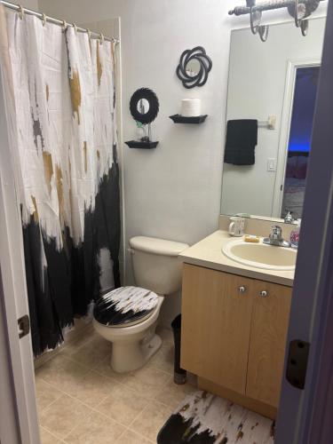 a bathroom with a toilet and a sink at Townhouse Retreat in Riverview