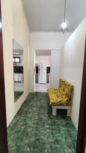 a living room with a couch and a green floor at Canoa Hostel in Canoa Quebrada