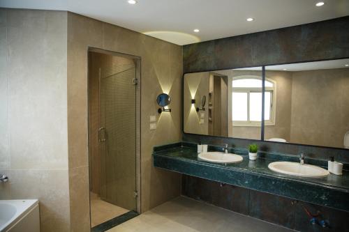 a bathroom with two sinks and a mirror at Munir`s residence 3 in Cairo