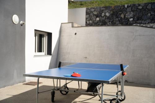 a blue ping pong table with a ball on it at Maison rayons de soleil in Bagnères-de-Bigorre