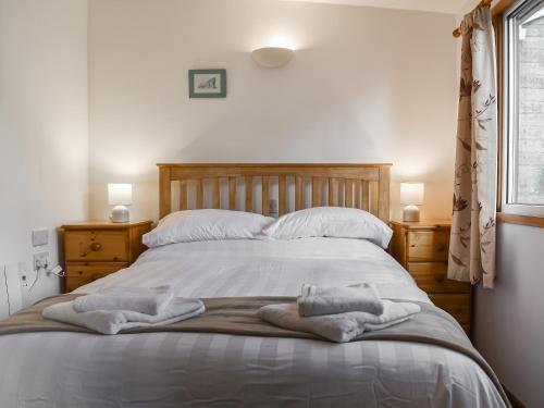 a bedroom with a bed with towels on it at Exmoor View in Blue Anchor