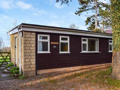 a small cabin with a black exterior at Exmoor View in Blue Anchor