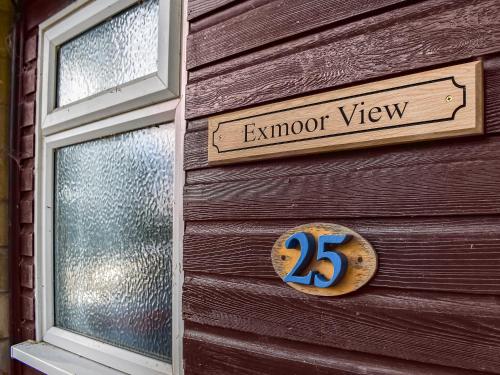 a sign on the side of a wooden building at Exmoor View in Blue Anchor