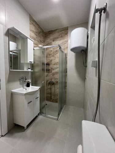 a bathroom with a shower and a sink at Urban Heart Residence in Sarajevo