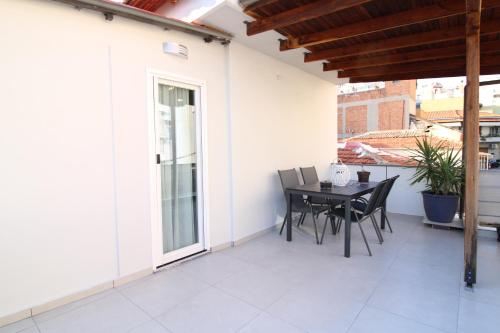a patio with a table and chairs on it at G&E Kavala Apartments in Kavala