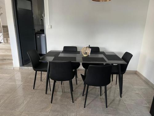 a black dining room table with black chairs at Blaclava Retreat in Balaclava