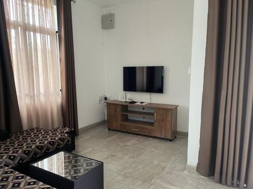 a living room with a flat screen tv on a wooden cabinet at Blaclava Retreat in Balaclava