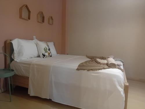 a bedroom with a bed with white sheets and pillows at Christi Iuxury Apartment in Preveza