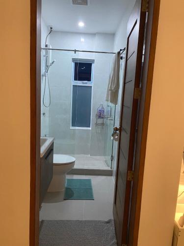 a bathroom with a shower and a toilet at Oia in Moalboal