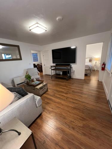 a living room with a couch and a flat screen tv at Valley Ford Hotel in Valley Ford