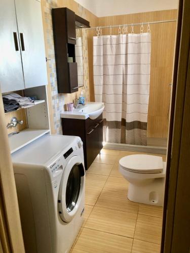 a small bathroom with a washing machine in it at Kallimasia Chios - Iraklis House in Chios
