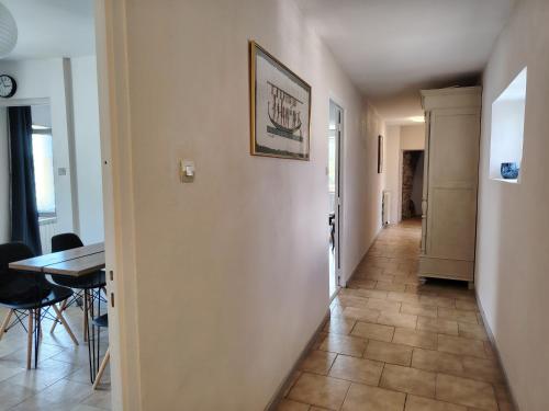 a hallway with a dining room and a table at Gîte Les Gorges du Tarn in La Cresse