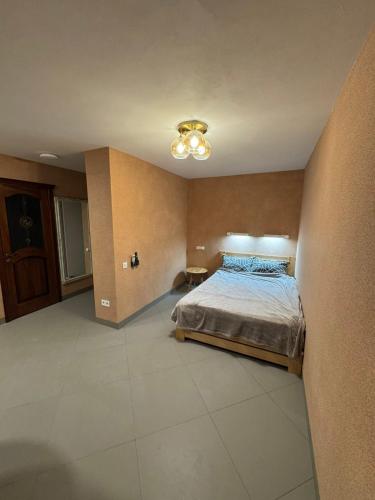 a large bedroom with a bed and a ceiling at Pilot House in Mykolaiv