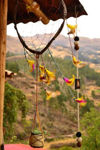 a group of birds hanging from a roof at Sacred Valley Mystic Tribe - Community Life in Pisac