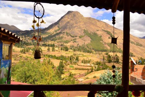 a view of a mountain from a window at Sacred Valley Mystic Tribe - Community Life in Pisac