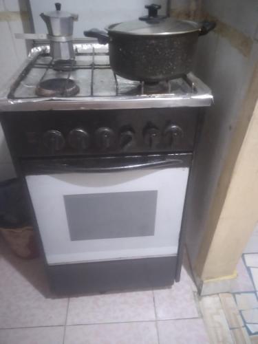 a stove with a pot on top of it at Affordable downtown studio steps to sea free wifi in Alexandria