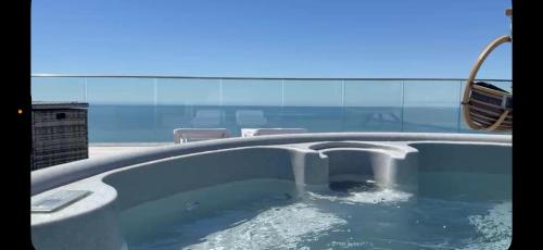 a plunge pool in a building with water at Hendre Coed Isaf Caravan Park in Barmouth