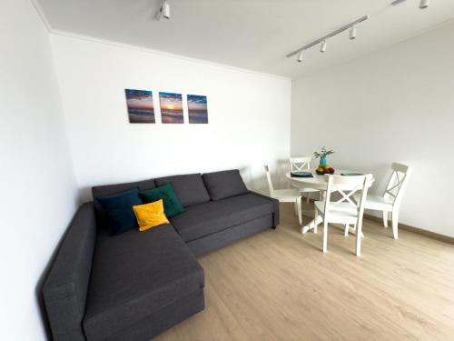 a living room with a couch and a table at 103 - Beachside Renovated 1BR apt w private garden in Cambrils