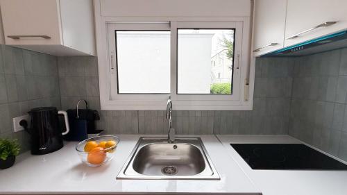 a kitchen counter with a sink and a window at 104 - Beachside Renovated 1BR apt 5 min from Beach in Cambrils