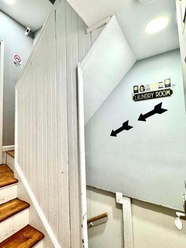 a stairwell with a wall with arrows on it at Private 1st floor Apartment - Only 5 min Away from Newark Airport and 30 min to NYC in Elizabeth