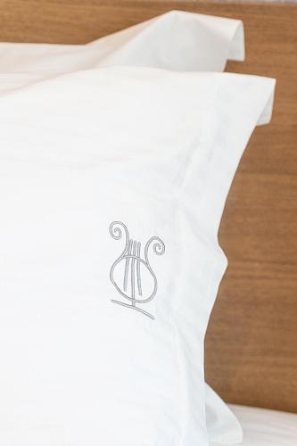 a piece of white paper with a logo on it at Ode Aristofanous - Urban Boutique Hotel in Athens