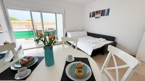 a room with a table with two plates of food on it at 109 - Beachside Renovated 1BR apt 5 min from Beach in Cambrils