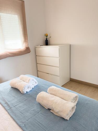 two towels on a bed in a bedroom at 106 - Beachside Renovated 1BR apt 5 min from Beach in Cambrils