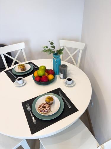 a white table with plates of food on it at 107 - Beachside Renovated 1BR apt 5 min from Beach in Cambrils