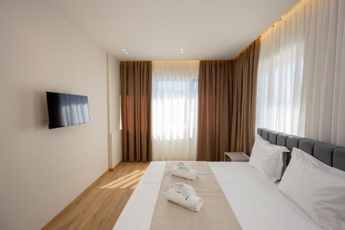 Ένα ή περισσότερα κρεβάτια σε δωμάτιο στο Infinity Apartments