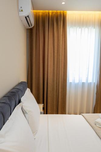 Ένα ή περισσότερα κρεβάτια σε δωμάτιο στο Infinity Apartments