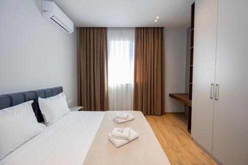 Ένα ή περισσότερα κρεβάτια σε δωμάτιο στο Infinity Apartments