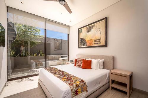 a bedroom with a bed and a large window at 2 BR Cabo Marina Walk to Beach & Private Jacuzzi in Cabo San Lucas