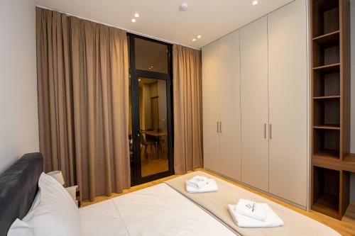 Ένα ή περισσότερα κρεβάτια σε δωμάτιο στο Infinity Apartments
