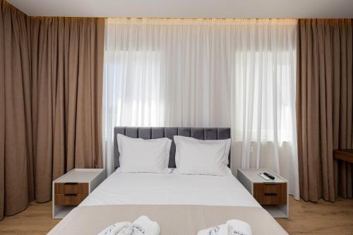 Ένα ή περισσότερα κρεβάτια σε δωμάτιο στο Infinity Apartments