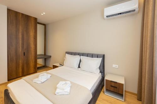 Ένα ή περισσότερα κρεβάτια σε δωμάτιο στο Infinity Apartments