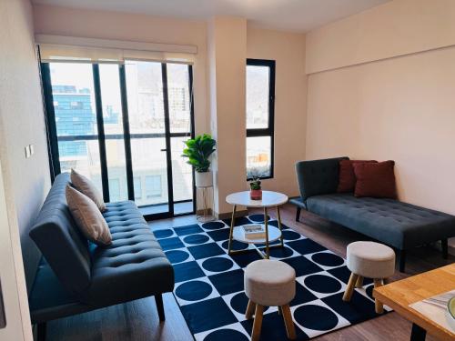 a living room with a couch and a table at Monterrico Polo Aparts 19 - Dpto de Estreno con Balcon frente Embajada USA in Lima