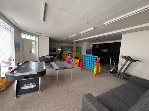 a living room with a ping pong table in the middle at 4 star holiday home in Nørre Nebel in Nørre Nebel