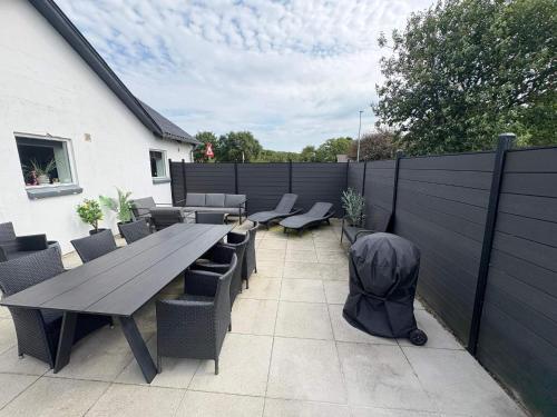 a patio with a table and chairs and a fence at 4 star holiday home in Henne in Henne