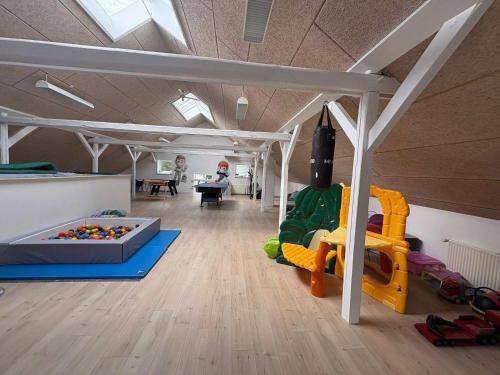 a room filled with lots of play equipment at 4 star holiday home in Henne in Henne