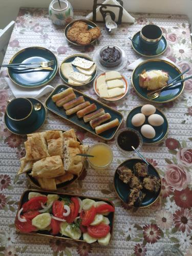 a table topped with plates of food and eggs at Vardzia Old Village in Vardzia