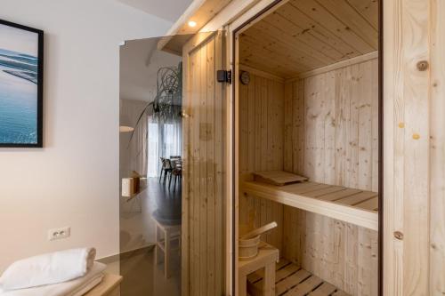 a sauna with wooden walls and a glass door at Villa Azzura in Vodice