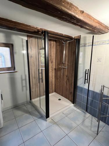 a shower with glass doors in a bathroom at Gîte Nicole proche du Europa Park in Heidolsheim