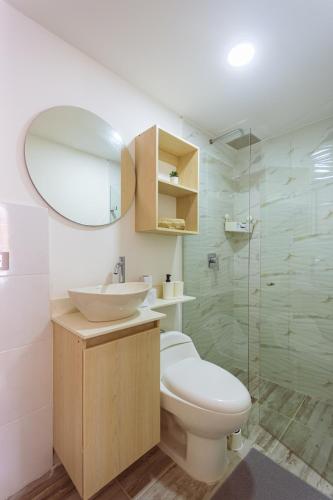 a bathroom with a toilet and a sink and a shower at Comuna Loft in Medellín