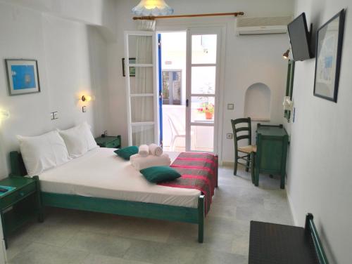 a bedroom with a bed with a teddy bear on it at Nostos Studios at Saint George beach Agios Georgios Chora Naxos town in Naxos Chora