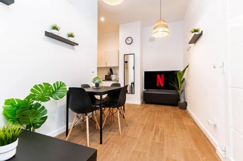 a dining room and living room with a table and chairs at Quiet & Modern Apartment in Valencia