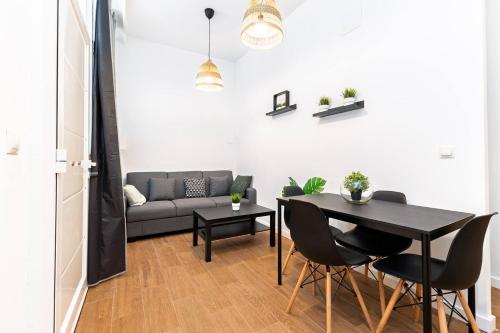 a living room with a table and a couch at Quiet & Modern Apartment in Valencia