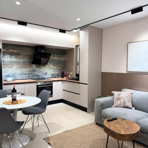 a living room with a couch and a table at Osik apartments villa 01 in Golem