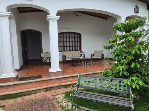 a bench sitting on a porch of a house at Hostal Casa San Mateo in León