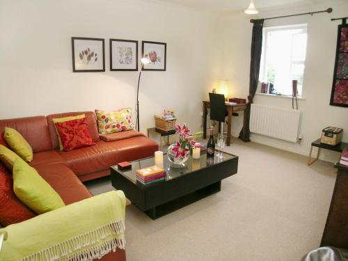 a living room with a couch and a coffee table at Waterside in Warkworth